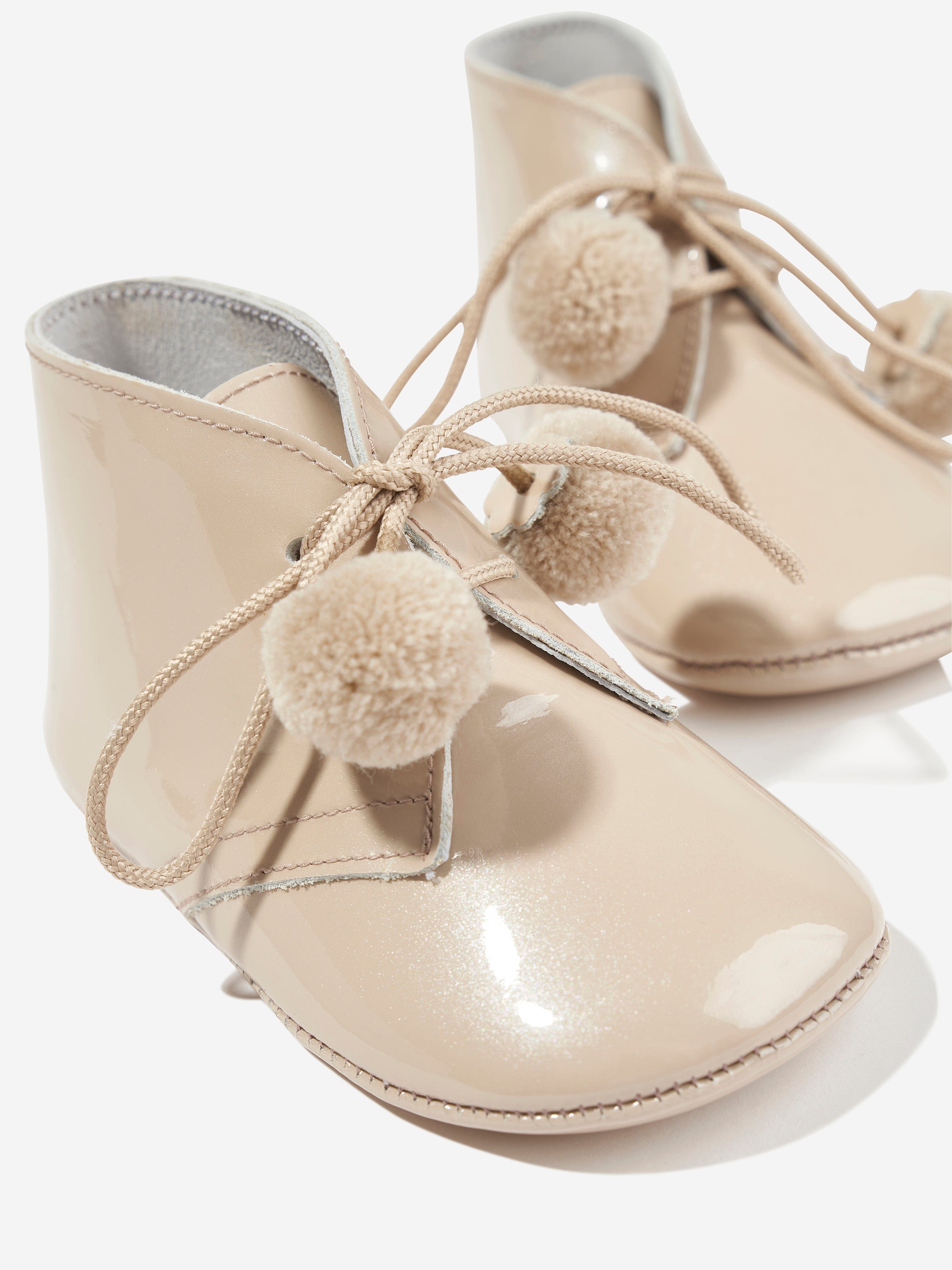 Andanines Baby Pom Pom Lace Up Booties in Beige