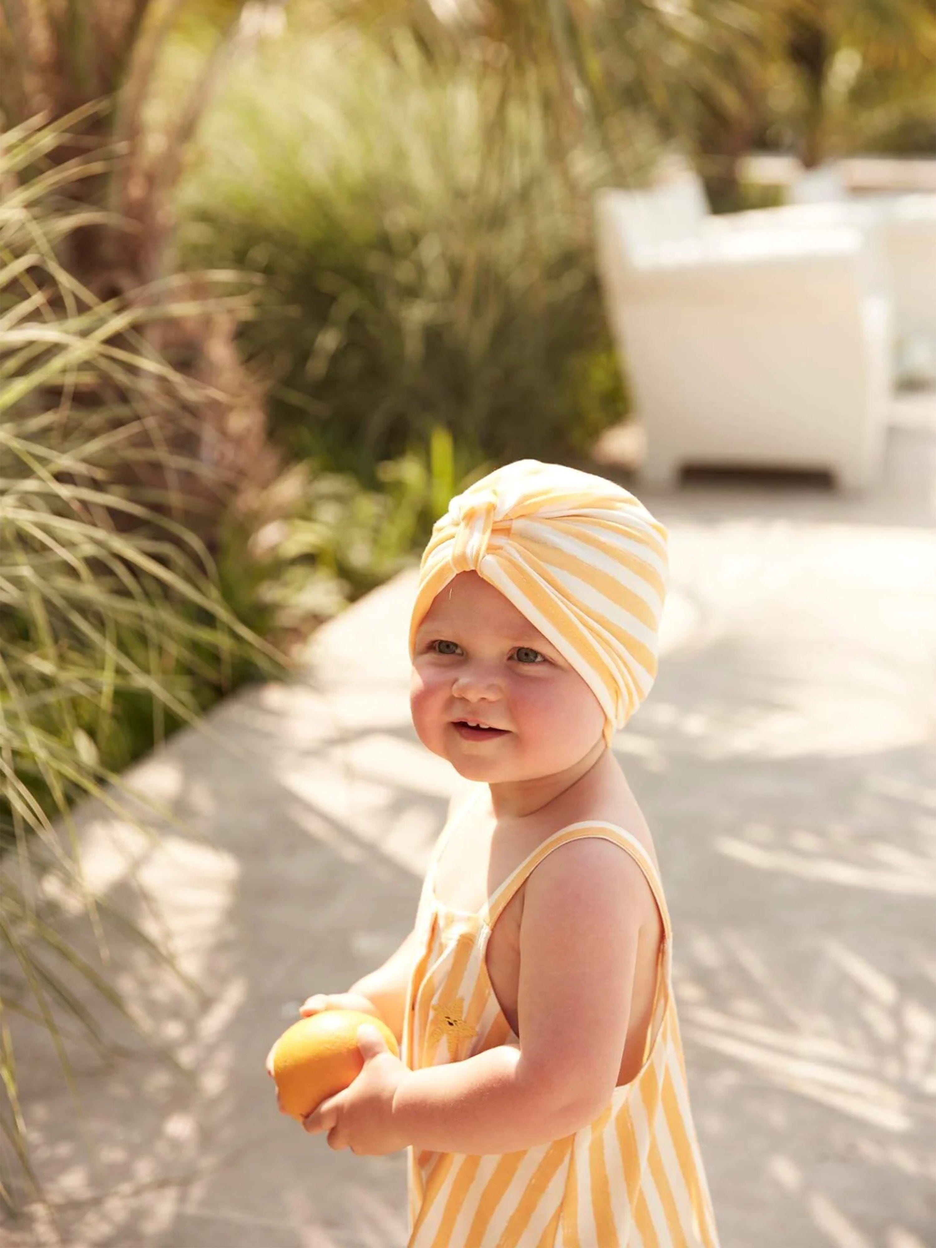 The Bonnie Mob Baby Girls Striped Cuttle Turban in Orange